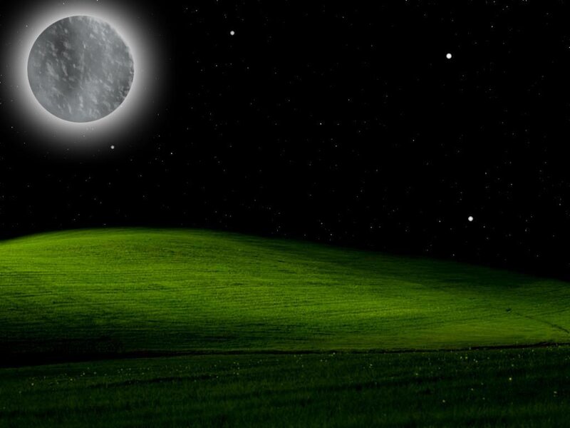 Green hill under moonlit sky