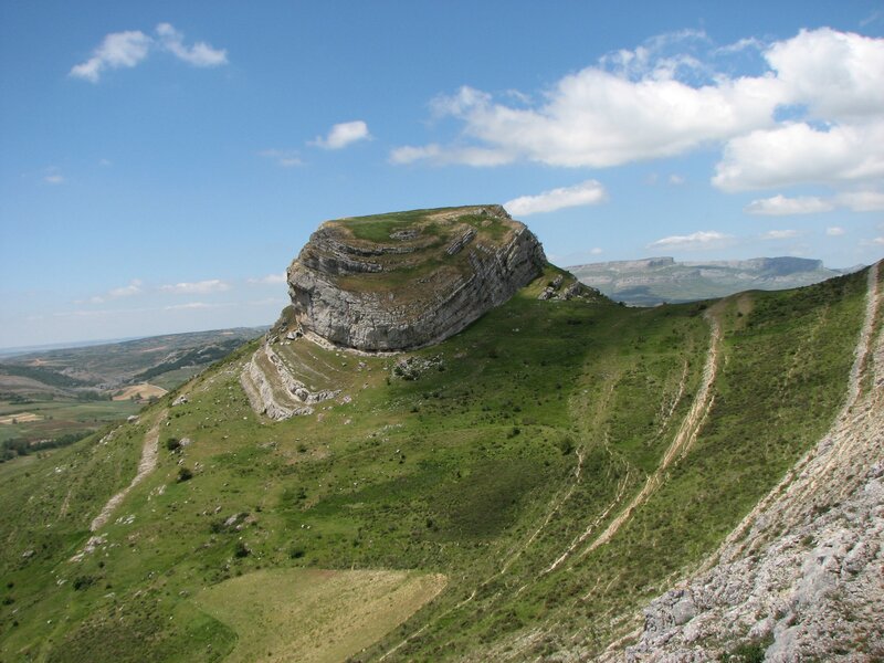 Green hill with rocky outcrop