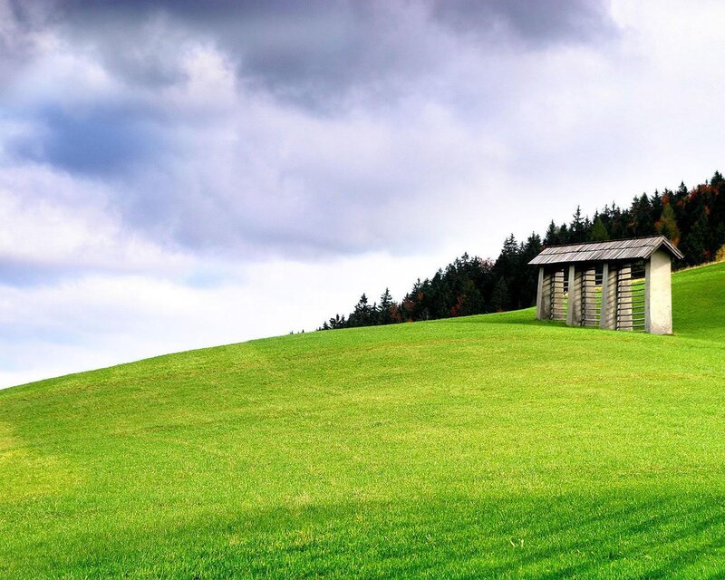 Green hill with wooden shelter