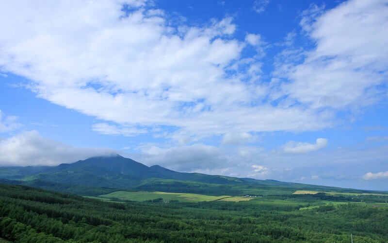 Green hills and blue sky landscape