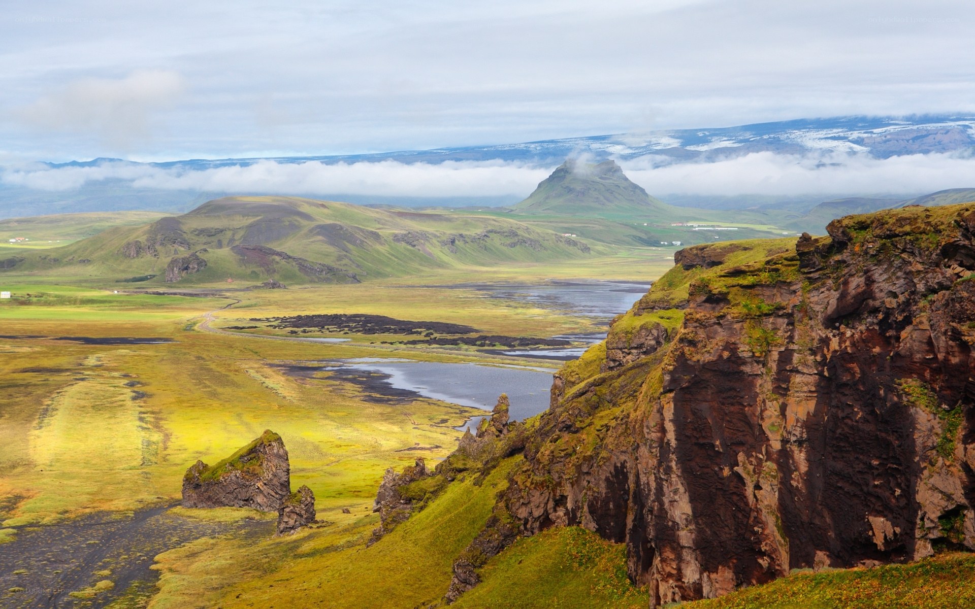 green hills and cliffs in iceland