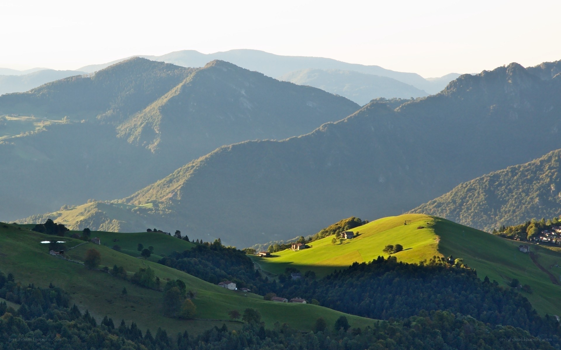 Green hills and distant mountains