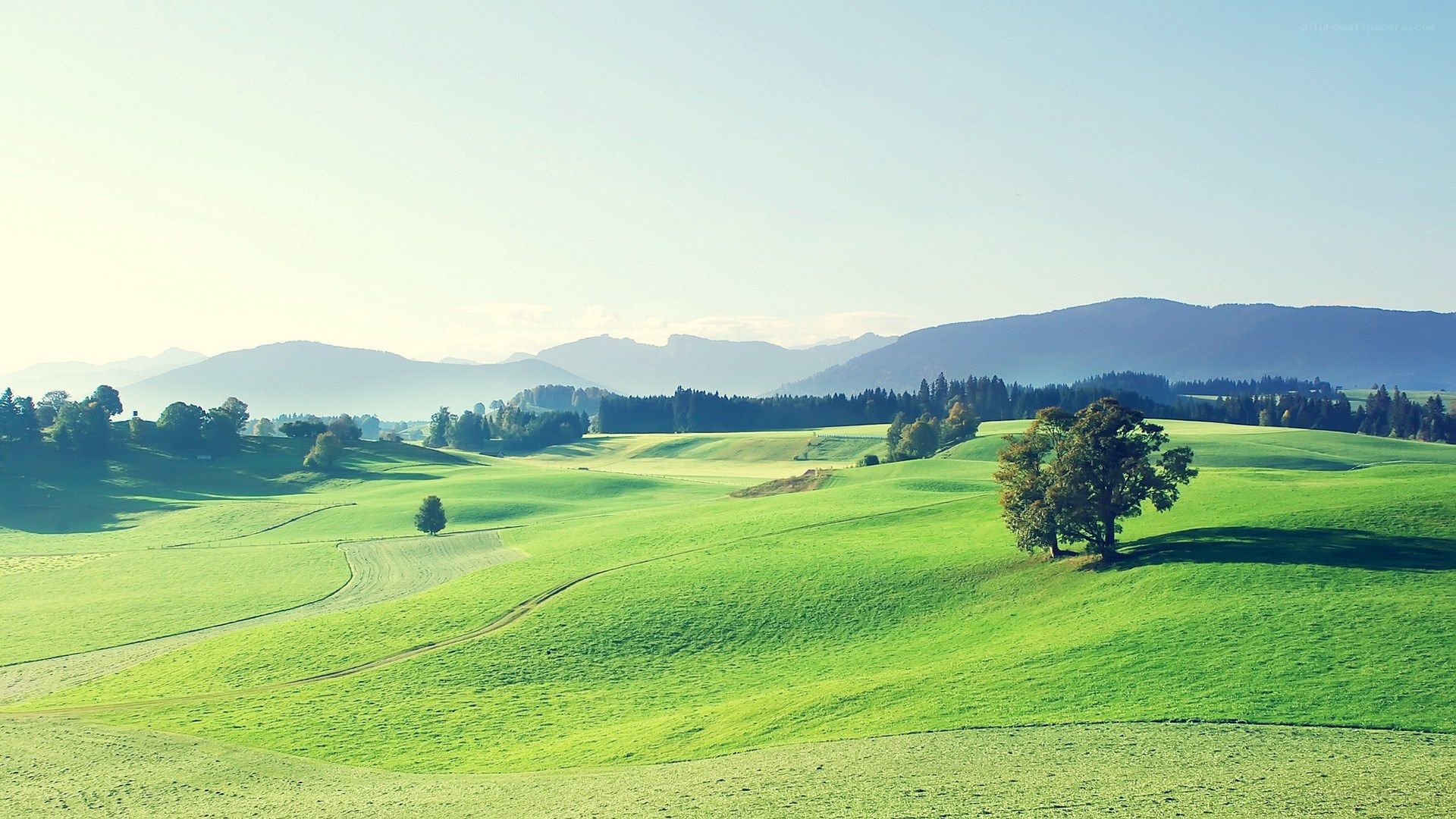 Green hills and distant mountains
