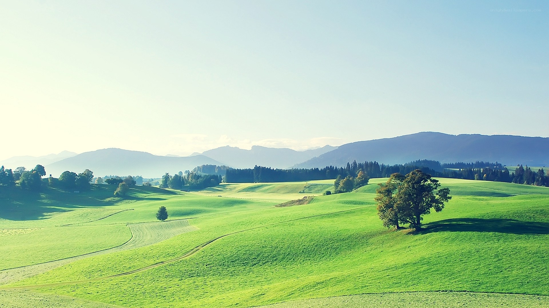 Green hills and distant mountains