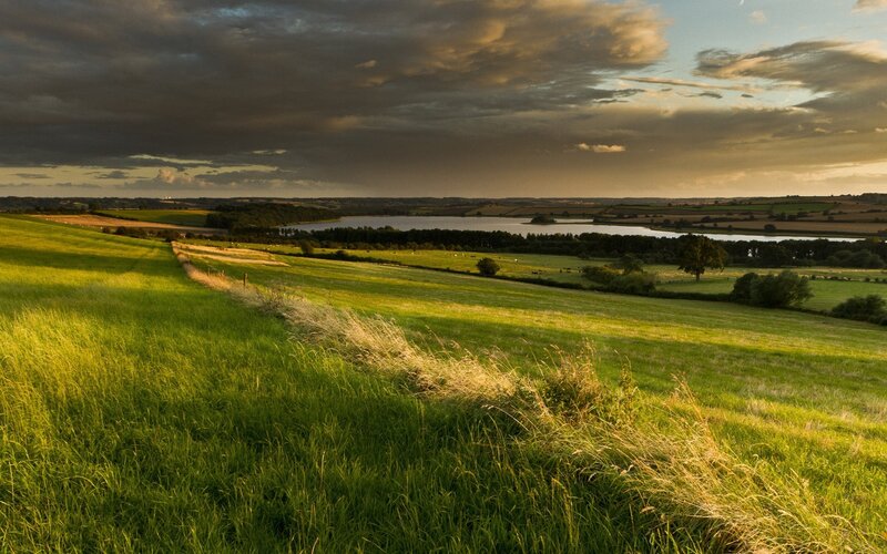 Green hills and lake at sunset