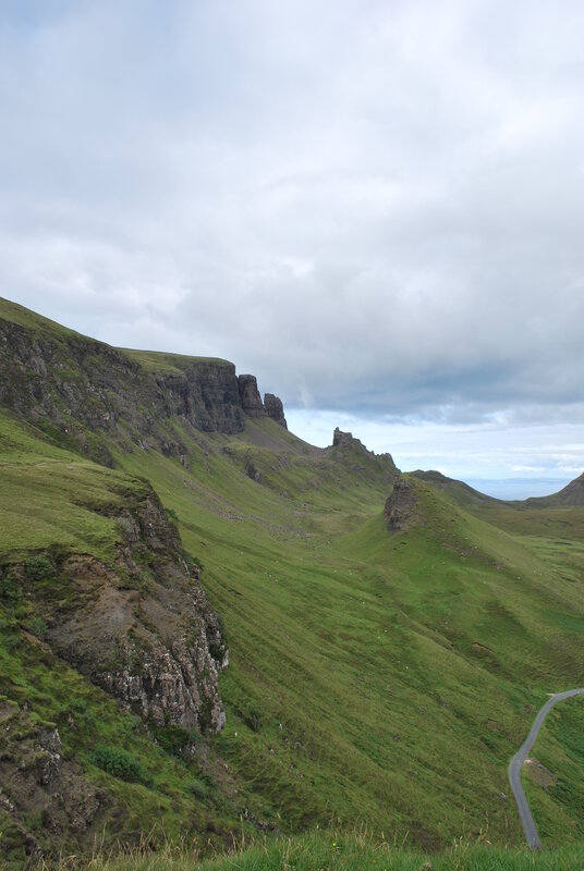 green hills and rocky cliffs