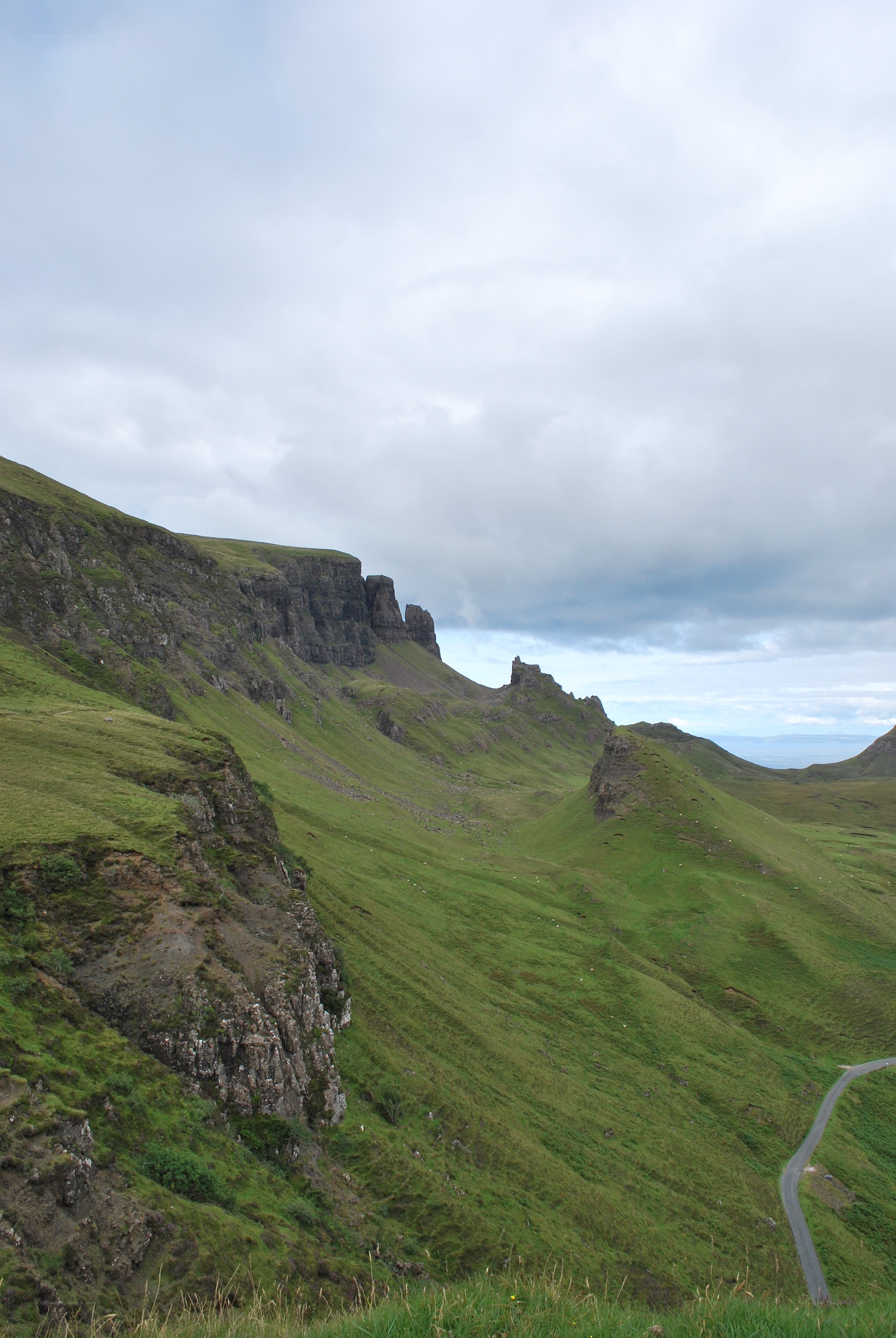 green hills and rocky cliffs