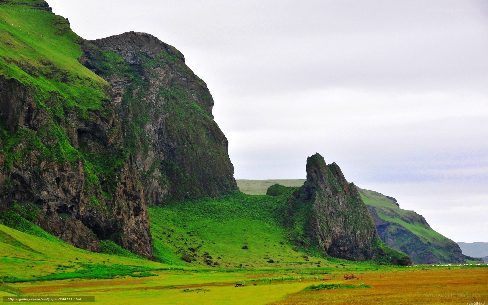 green hills and rocky cliffs