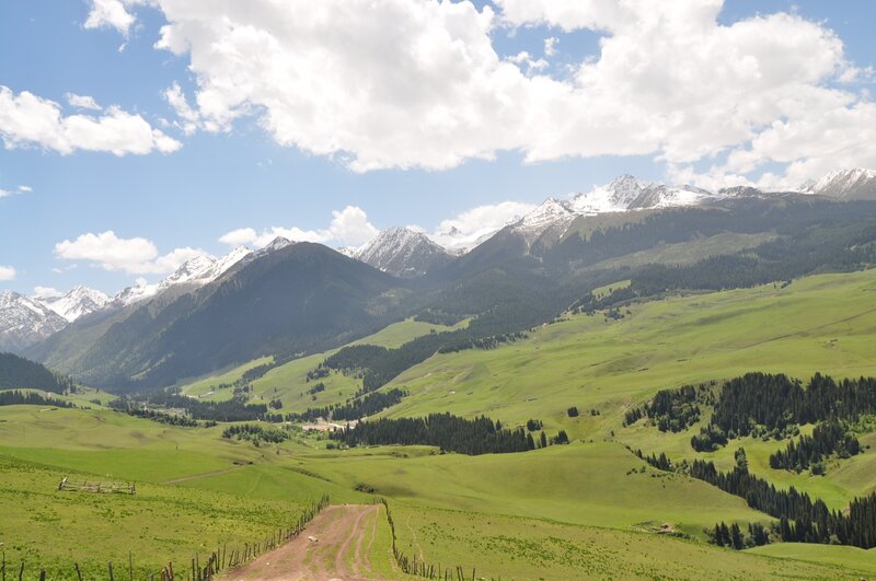 Green hills and snow-capped mountains