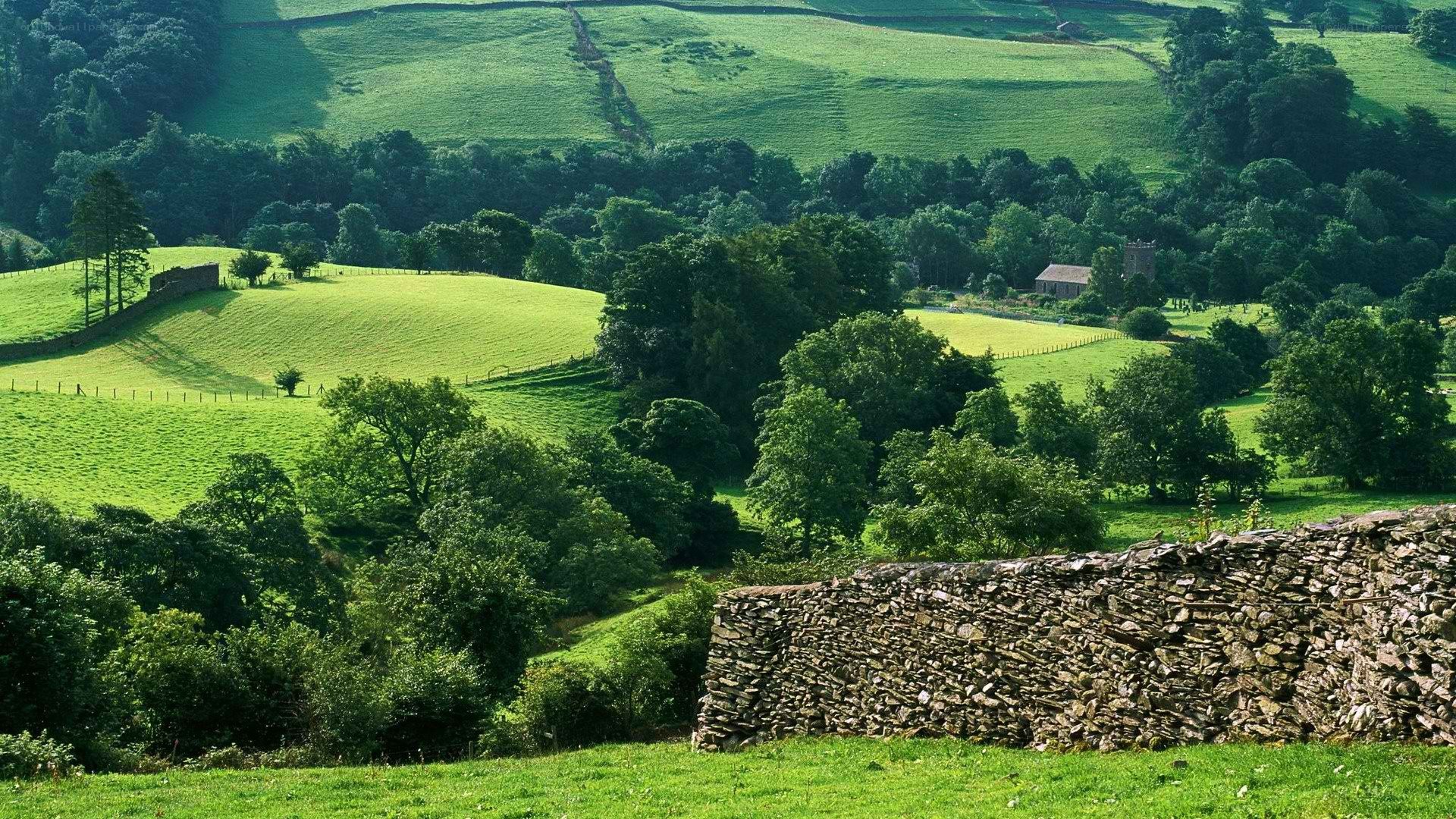 green hills and stone wall
