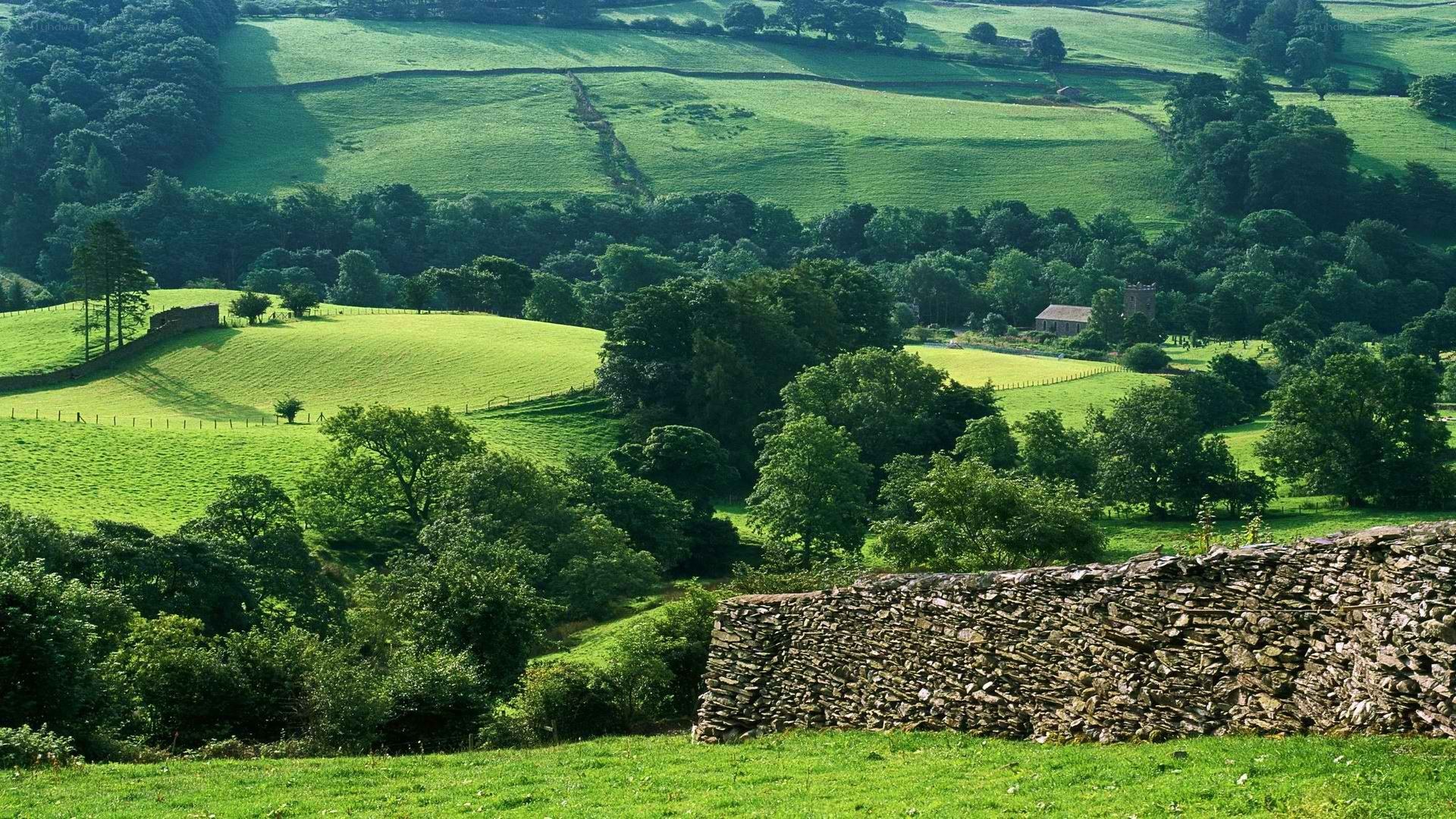 green hills and stone wall