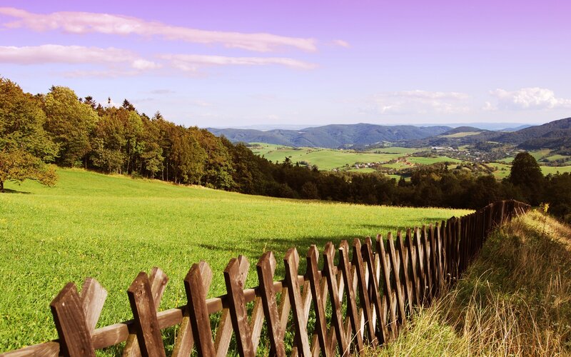 Green hills and wooden fence