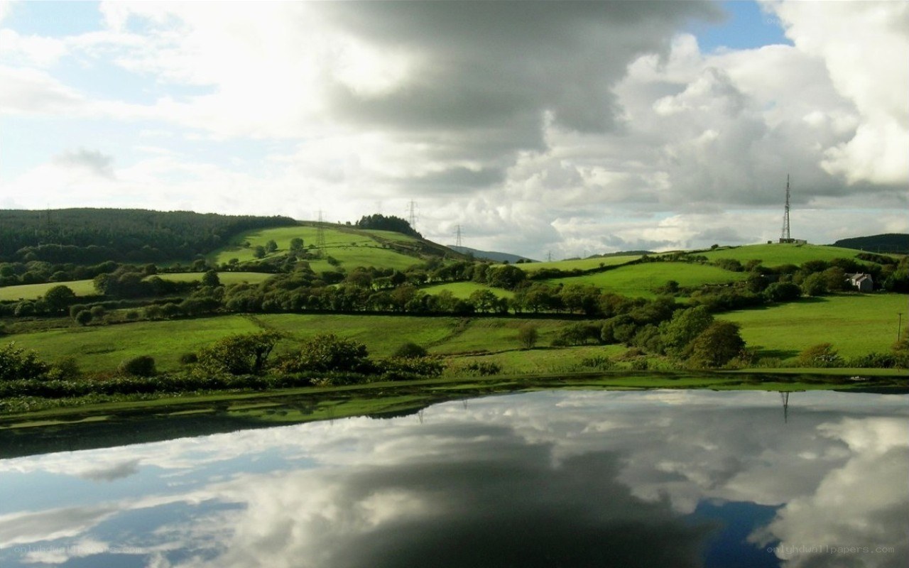 Green hills reflected in a lake
