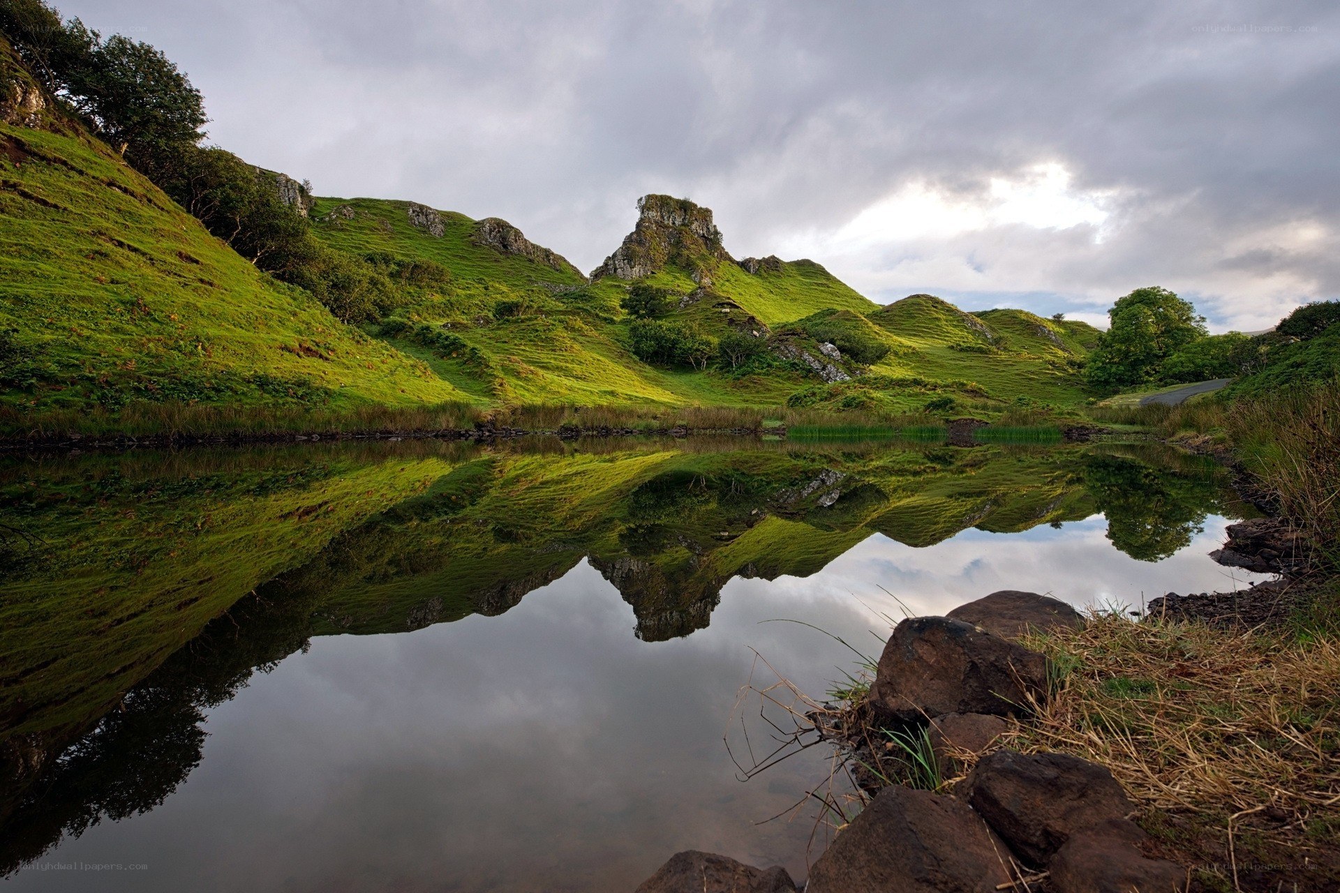 Green hills reflected in a lake