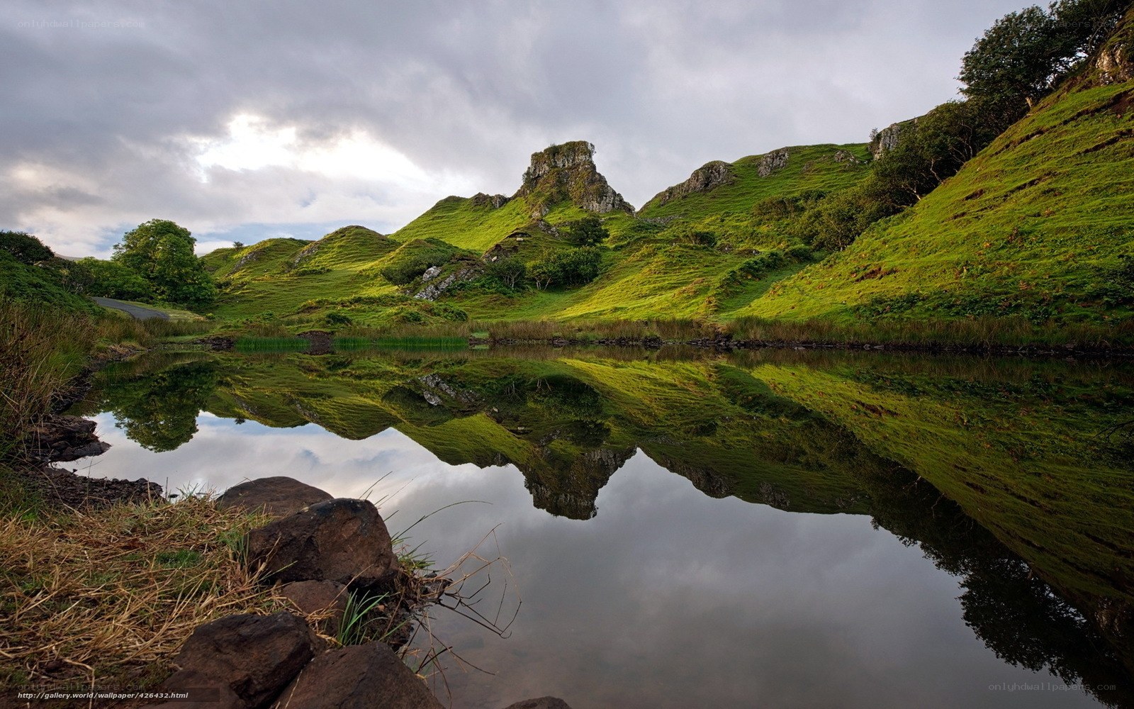 Green hills reflected in a lake