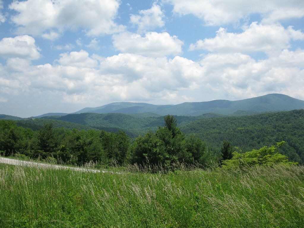 Green hills under a cloudy sky