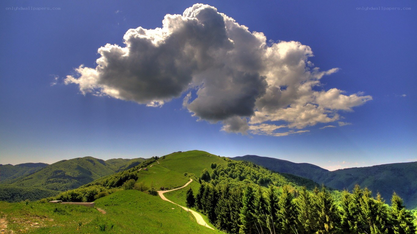 Green hills under a cloudy sky