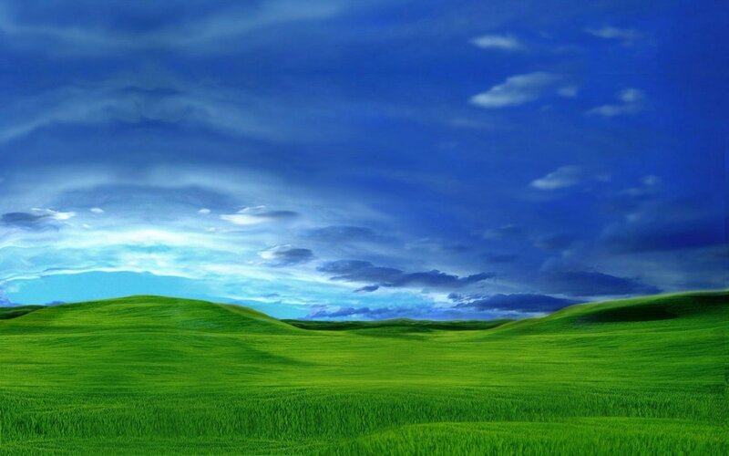 green hills under blue sky