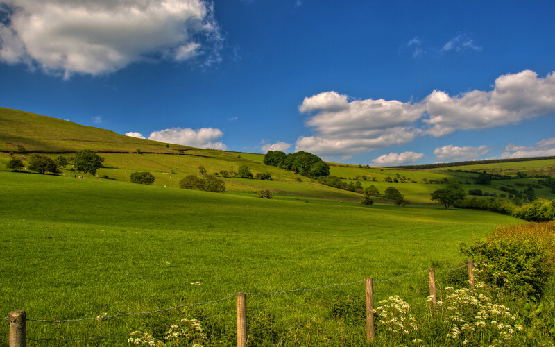 Green hills under blue sky