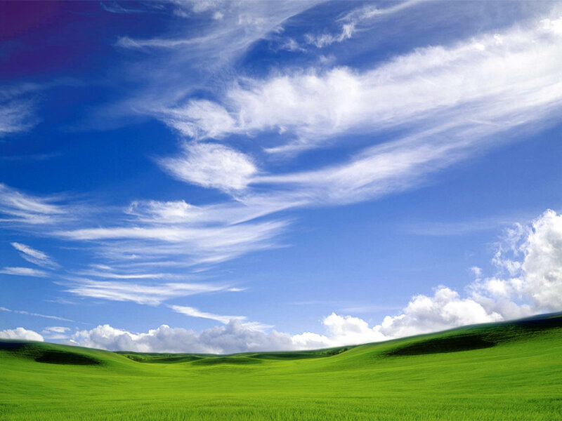 Green hills under blue sky