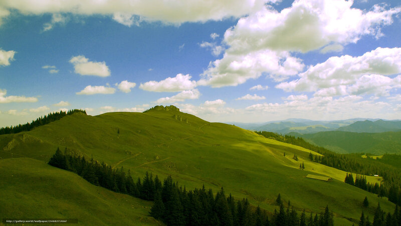 Green hills under blue sky