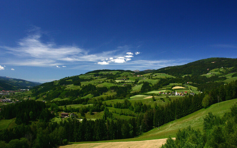 Green hills under blue sky