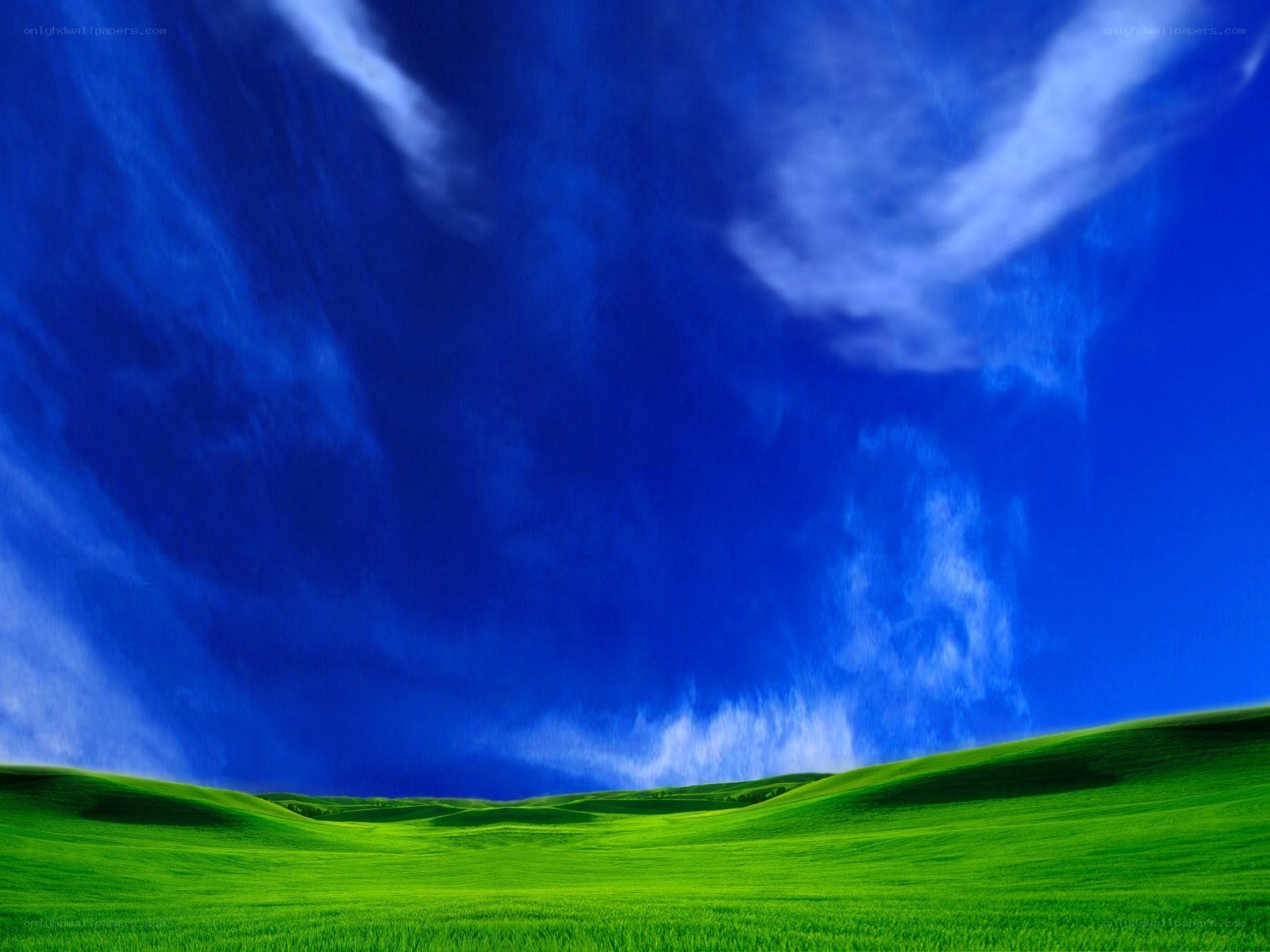 green hills under blue sky