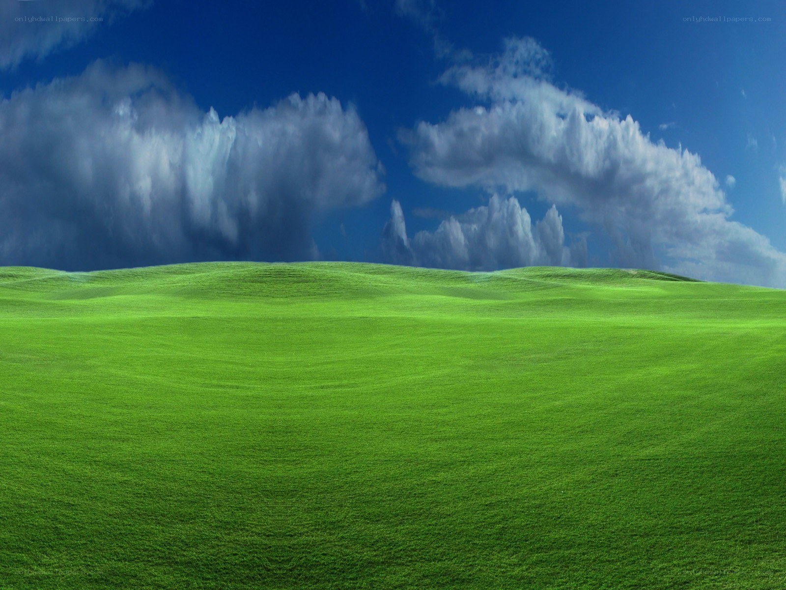 Green hills under blue sky