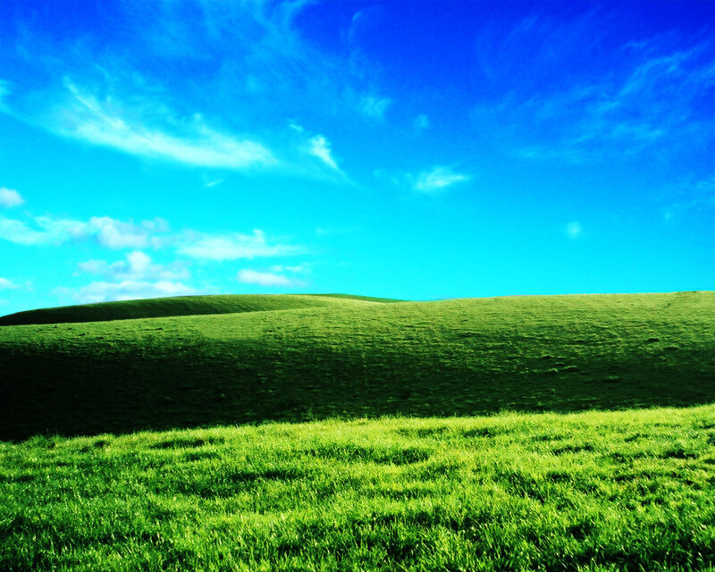 Green hills under blue sky