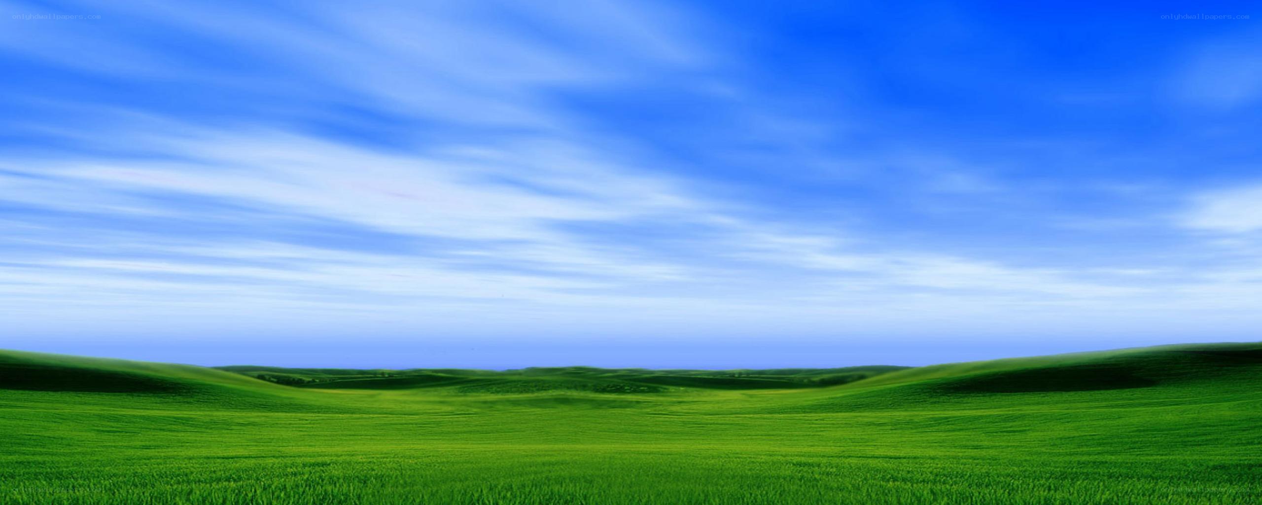green hills under blue sky