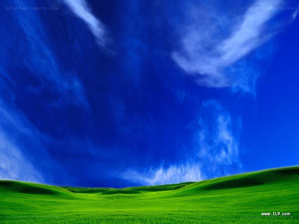 Green hills under blue sky