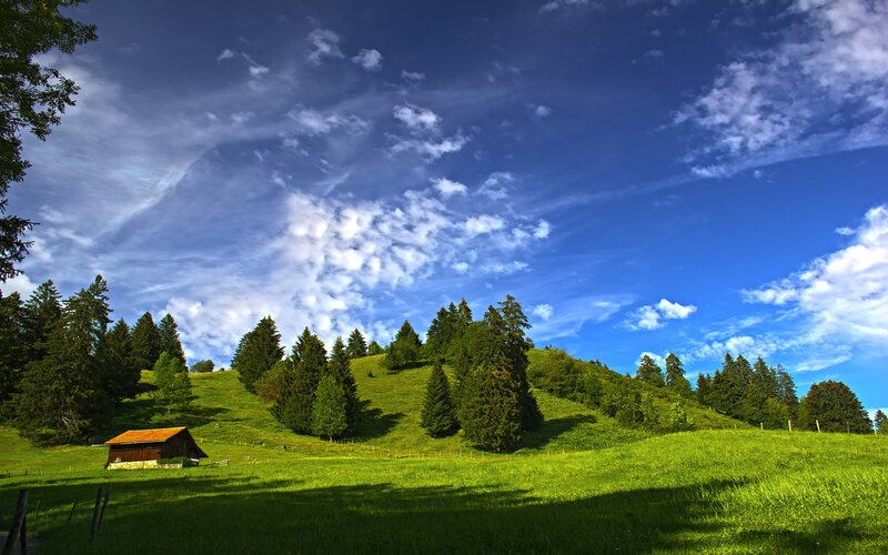 Green hills under blue sky