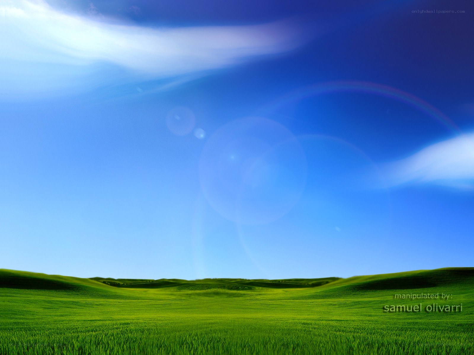 green hills under blue sky