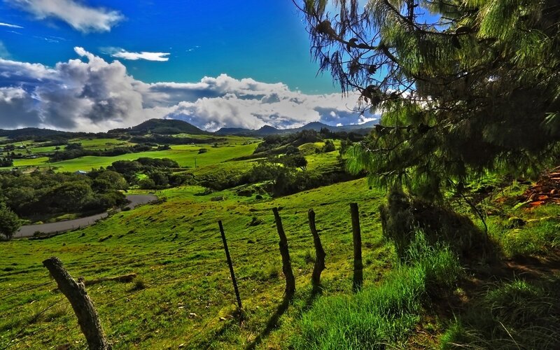 Green hills under blue sky