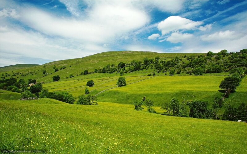 Green hills under blue sky
