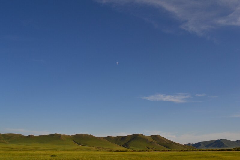 Green hills under blue sky