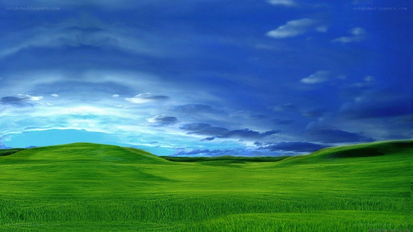 Green hills under blue sky