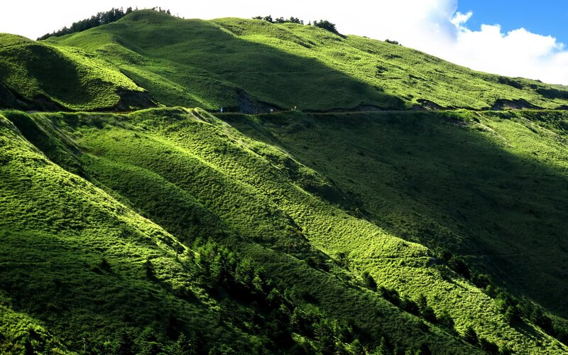 Green hills under blue sky