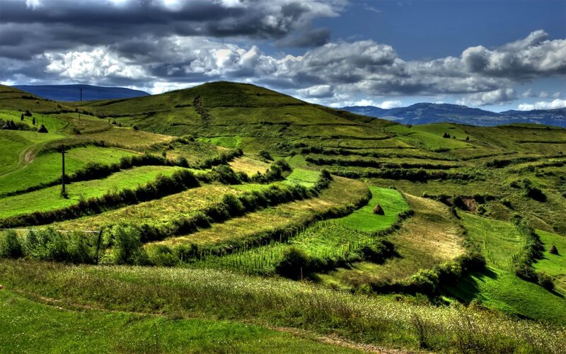 Green hills under cloudy sky