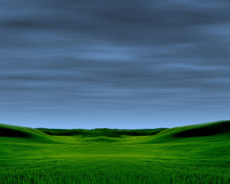 Green hills under cloudy sky
