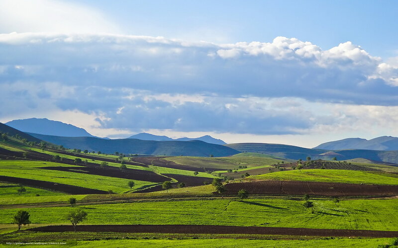 Green hills under cloudy sky