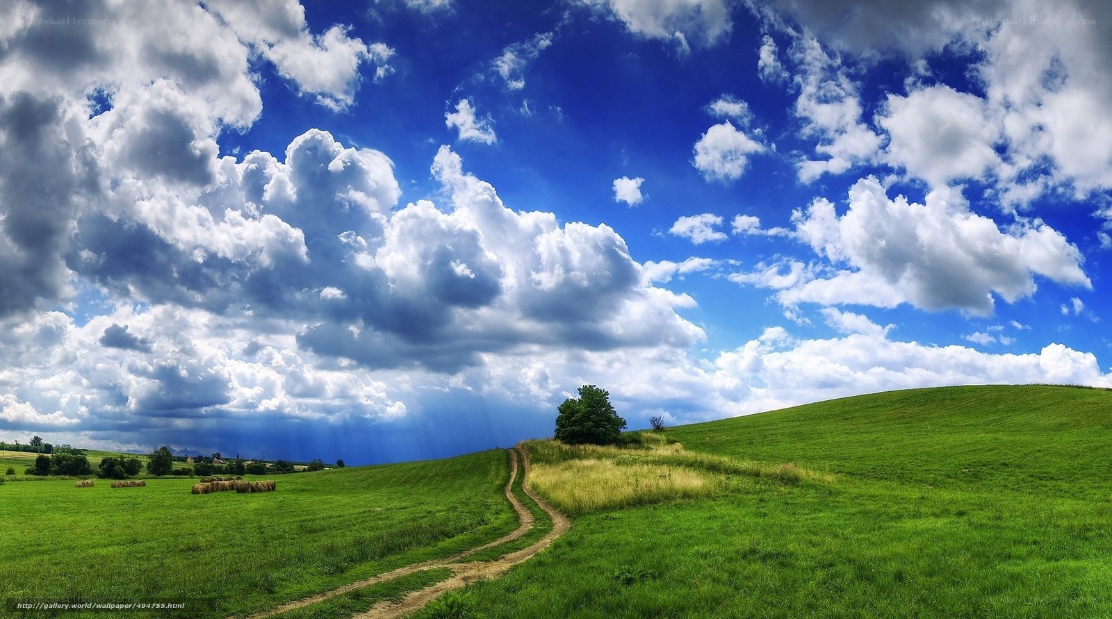 Green hills under cloudy sky