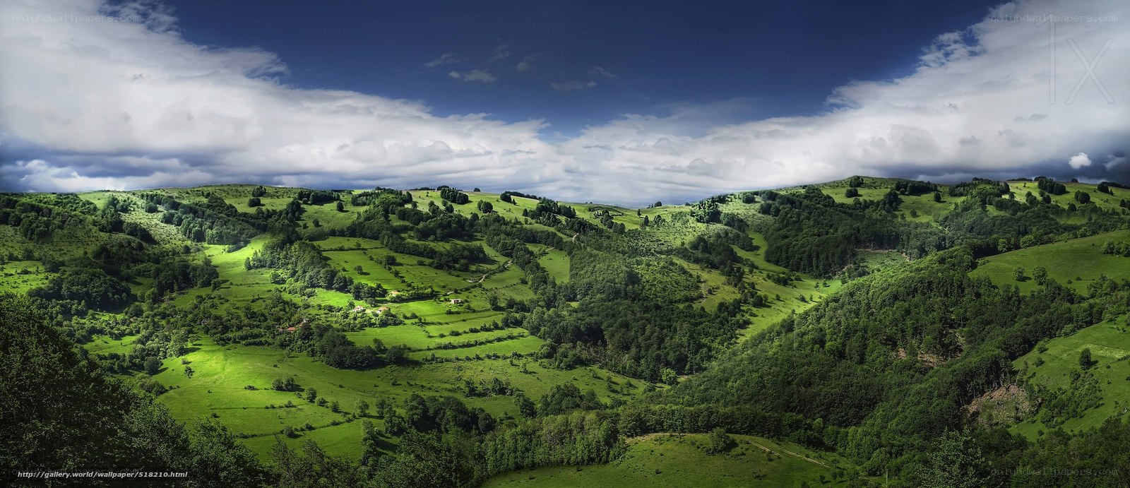 Green hills under cloudy sky
