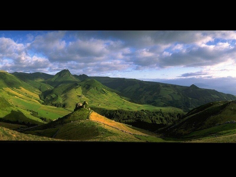 Green hills under cloudy sky