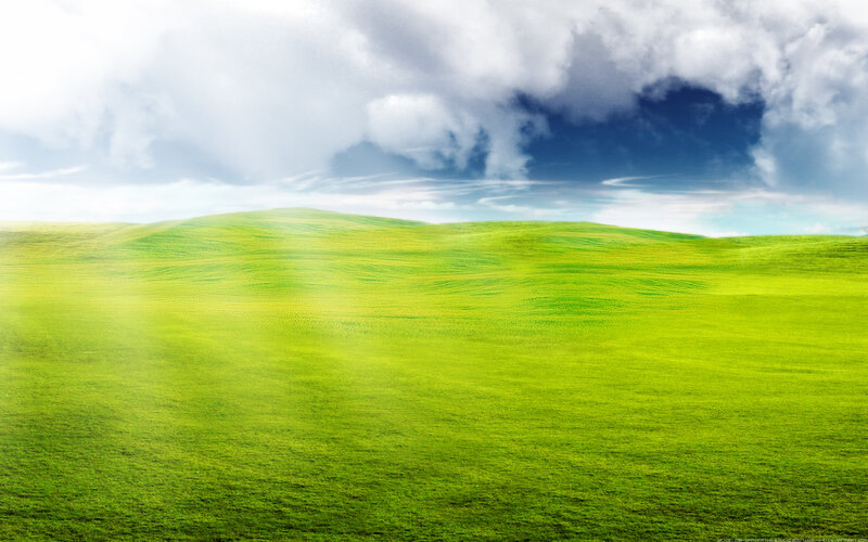 Green hills under cloudy sky
