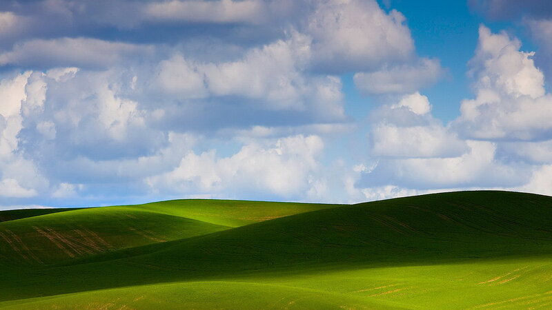 Green hills under cloudy sky