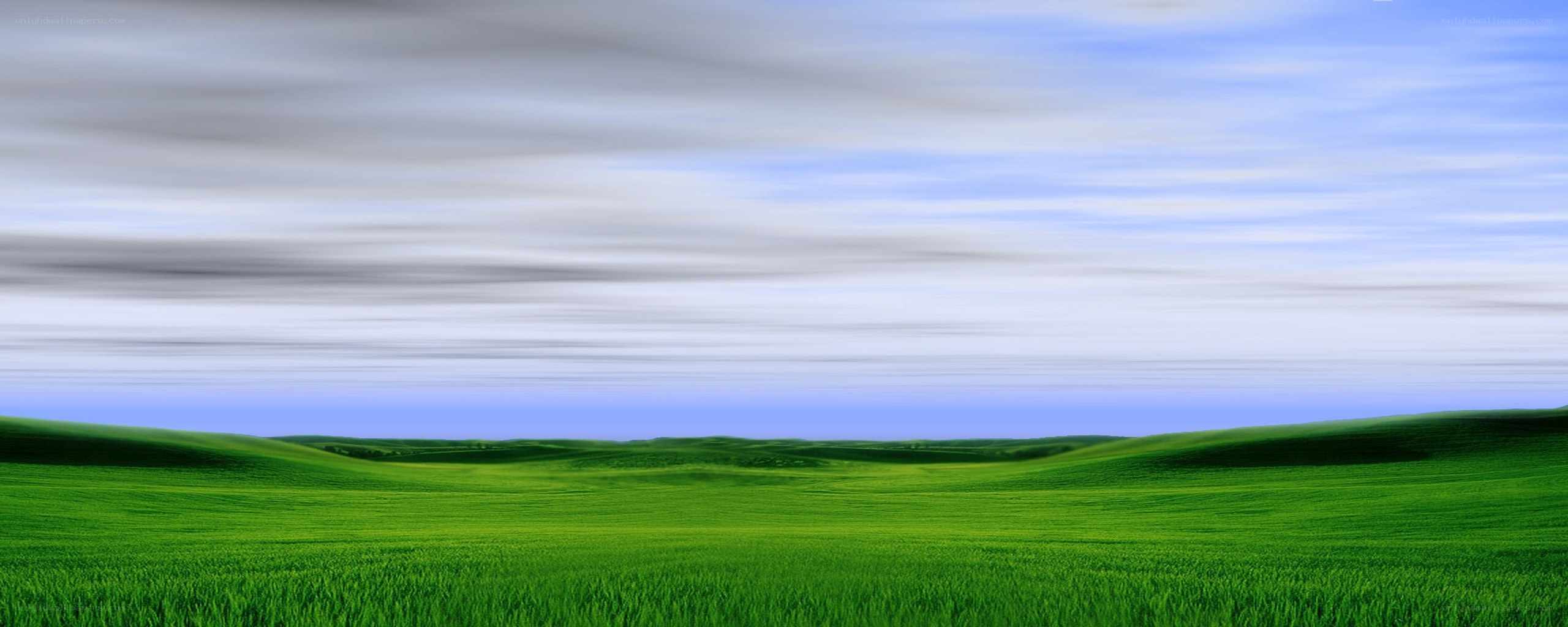 Green hills under cloudy sky