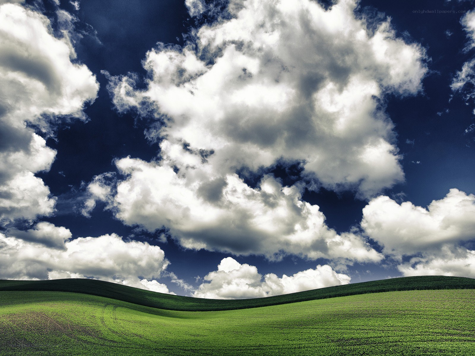 Green hills under cloudy sky
