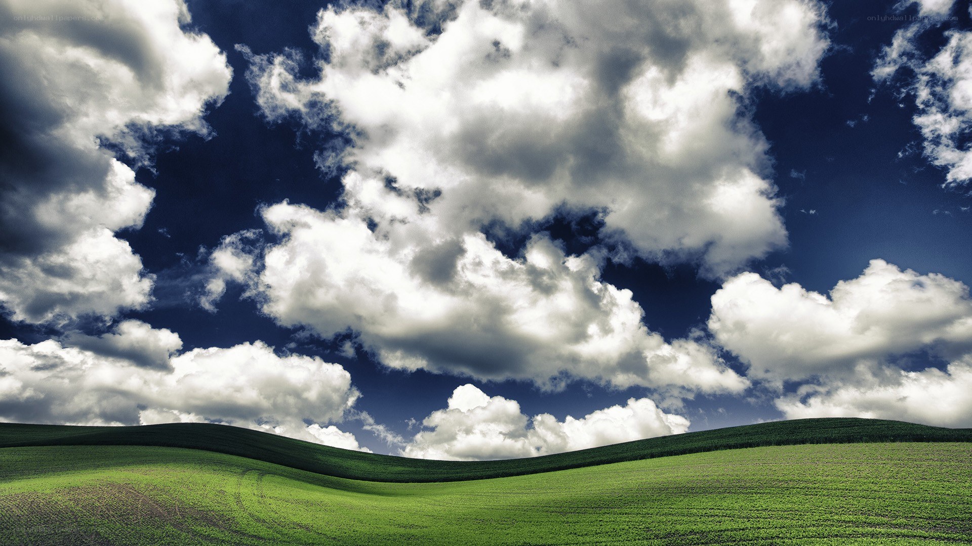 Green hills under cloudy sky