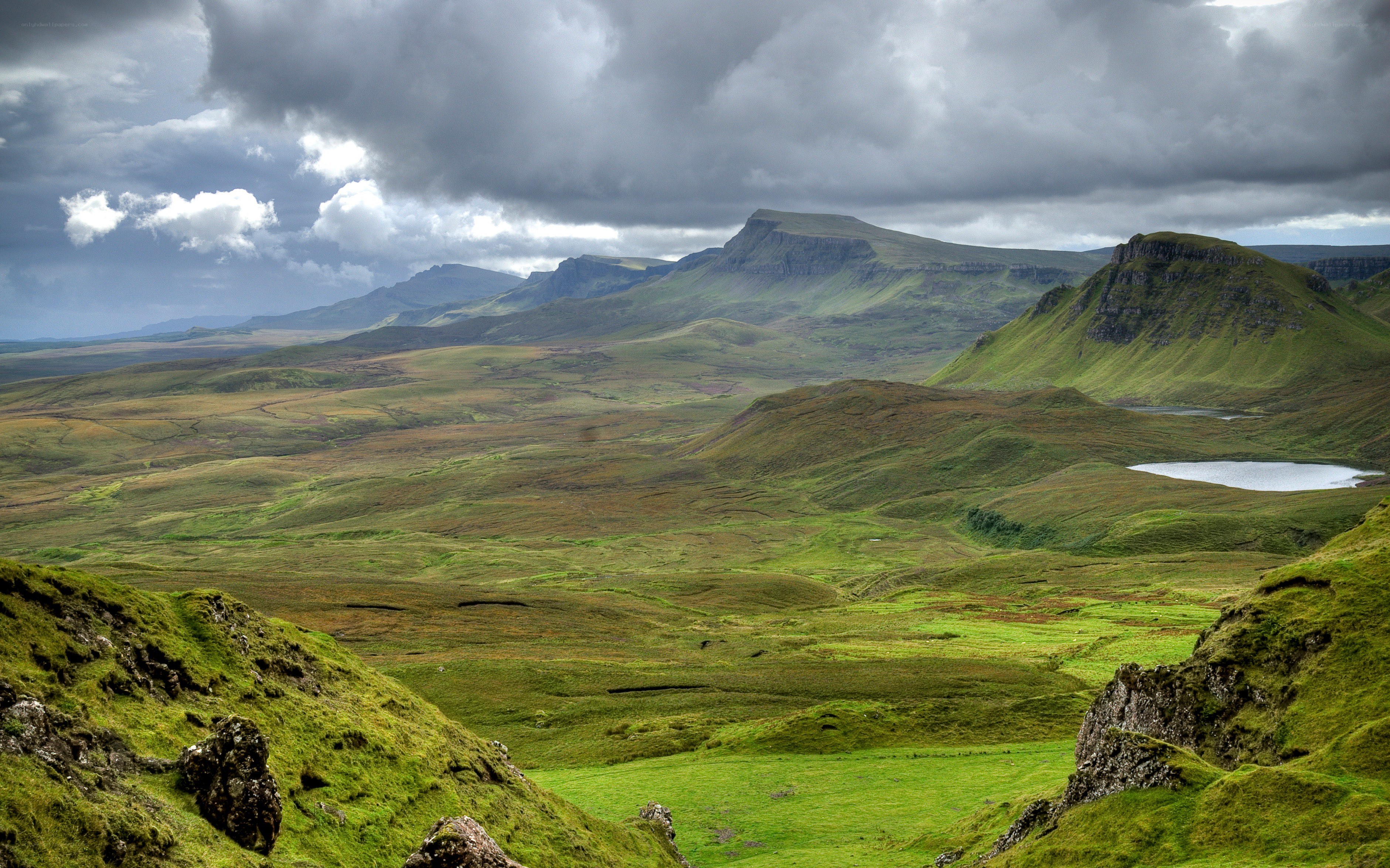 Green hills under cloudy sky